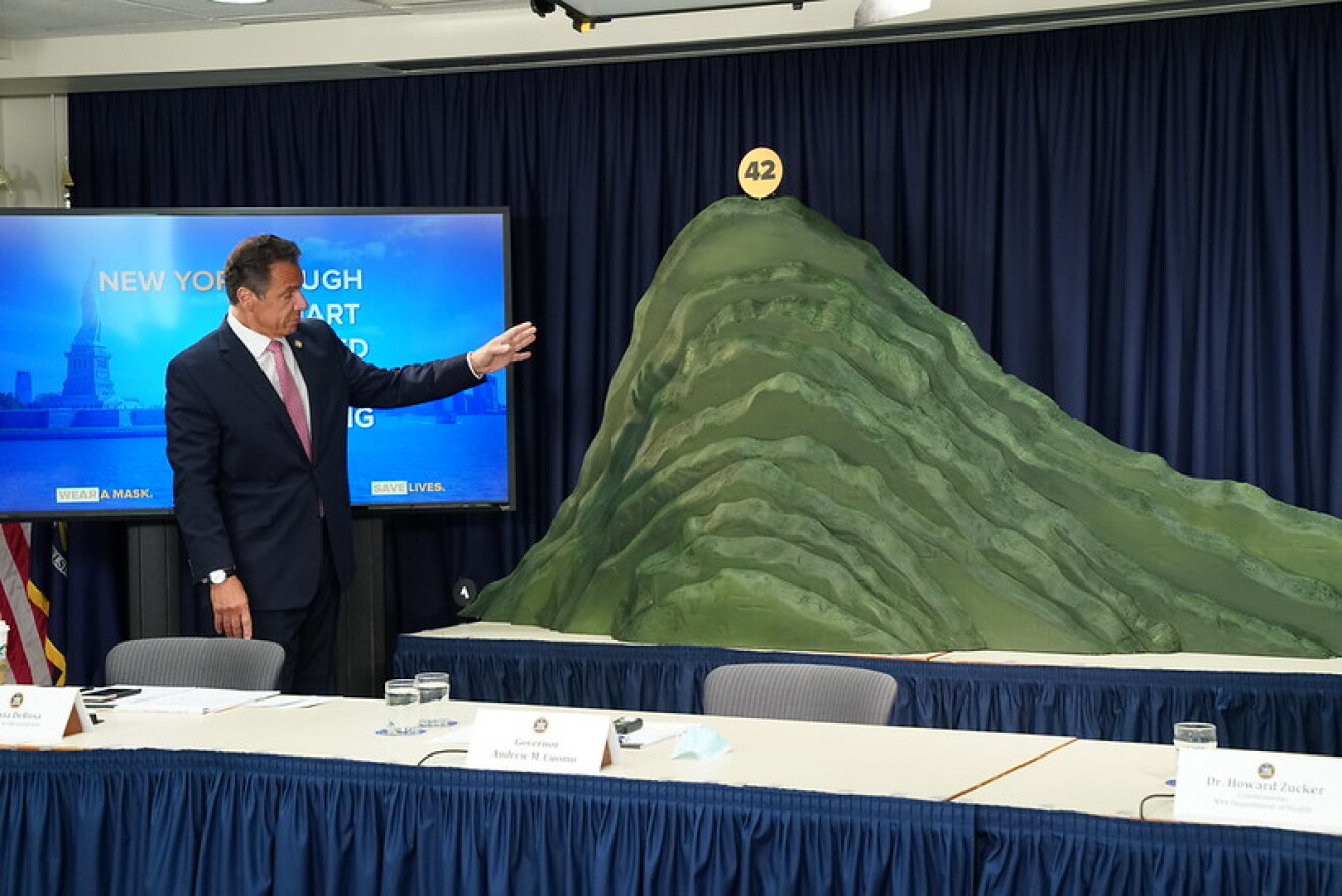 Gov. Andrew Cuomo on July 1 with a papier-mÃ¢chÃ© depiction of New York's journey with COVID-19.